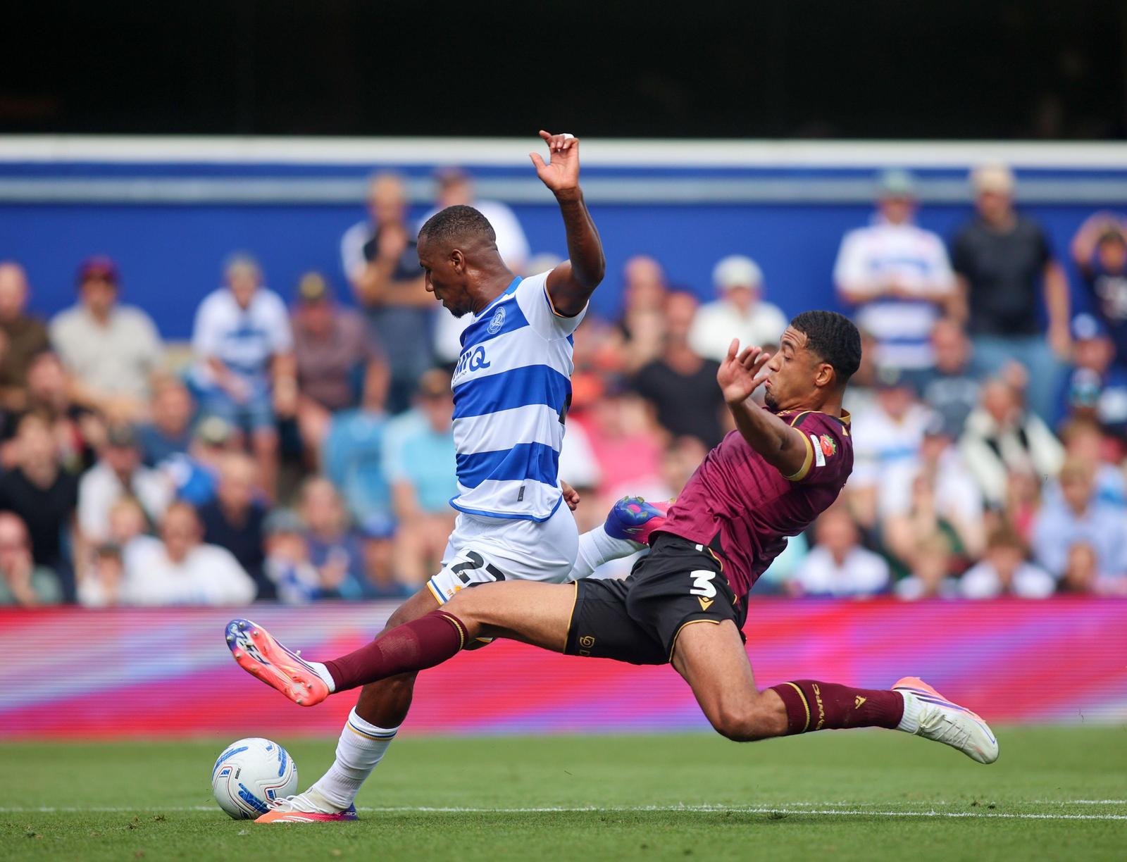 3FB43WY Queens Park Rangers's Richard Kone (left) battles for the ball with Bolton Wanderers' Chris Forino during the Sky Bet Championship match at MATRADE Loftus Road Stadium, London. Picture date: Saturday August 22, 2026.